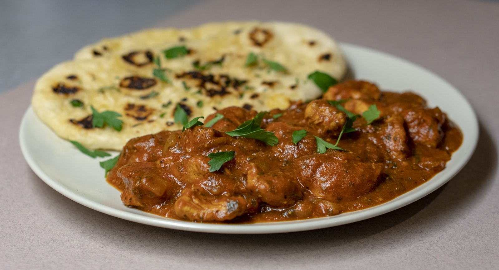 Aromatic Indian curry served with fresh naan bread