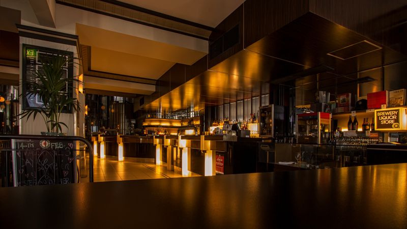 Warm, modern restaurant interior with tables set for dining